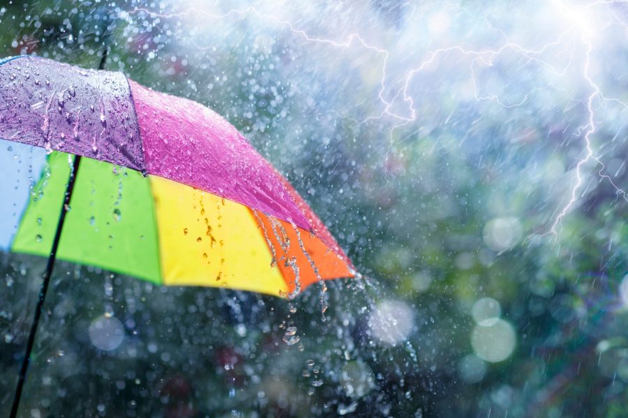 Rain On Rainbow Umbrella Weather Concept Spring And Fall Shower With Abstract Defocused Drops And Light Flare Effects