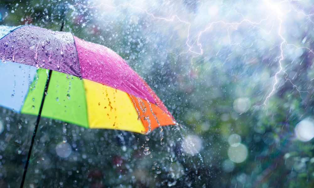 Rain On Rainbow Umbrella Weather Concept Spring And Fall Shower With Abstract Defocused Drops And Light Flare Effects